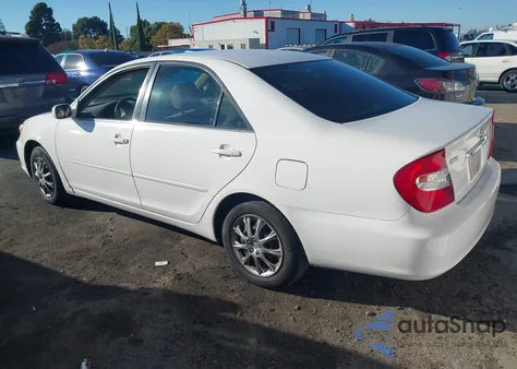 2003 Toyota Camry Le z USA, uszkodzony, nr VIN JTDBE32K730188966